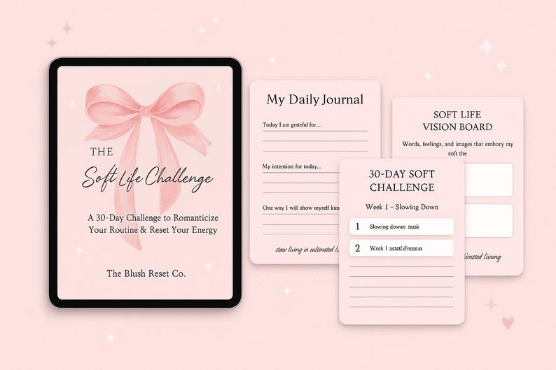 May include: A digital tablet and several pink paper cards with text. The tablet displays "The Soft Life Challenge" with a bow graphic. The cards include "My Daily Journal," "Soft Life Vision Board," and a "30-Day Soft Challenge" guide.