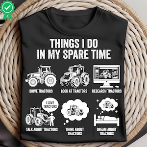 May include: Black t-shirt with white text and tractor graphics. The text reads "THINGS I DO IN MY SPARE TIME" with illustrations of tractors and related activities like "DRIVE TRACTORS" and "DREAM ABOUT TRACTORS."