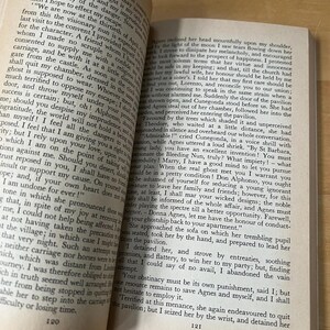 May include: Open book with text on aged paper. The pages are slightly yellowed, and the text is in a classic serif font. The book is open, revealing two facing pages filled with paragraphs. The image captures the essence of reading and literature.