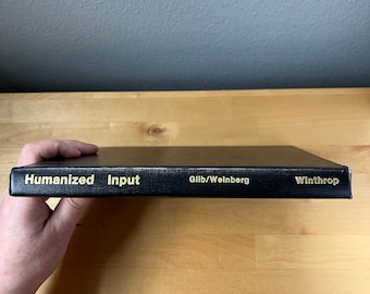 May include: Black book with gold lettering on the spine. The title is "Humanized Input" by Gilb/Weinberg. The book is published by Winthrop.