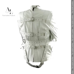 May include: White leather jacket with multiple straps and metal buckles. The jacket has a high collar and is designed with a series of horizontal straps across the back and chest. The text "Pure leather Products" is visible.