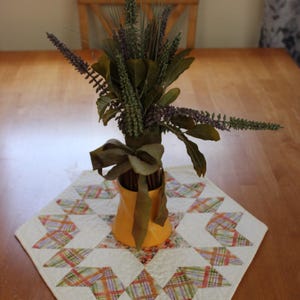 Quilted round table topper, 100% cotton; soft Autumn colors in a beautiful diamond pattern; reverses to a cream for use throughout the year