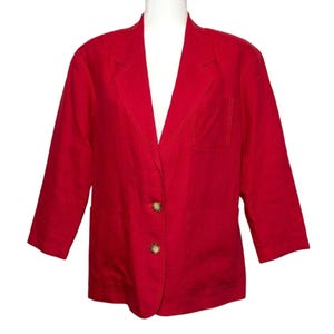 May include: A bright red blazer with three-quarter sleeves. The blazer has two front pockets and two brown buttons. The blazer is displayed on a white mannequin.