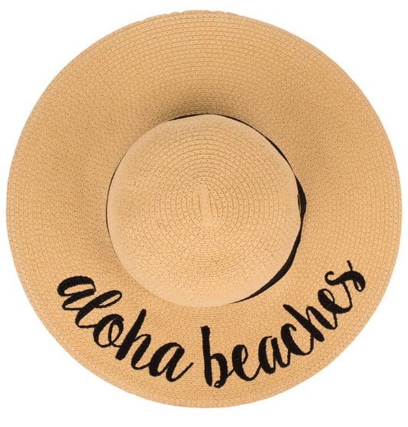 May include: A straw sun hat with a black ribbon and the text "Aloha Beaches" embroidered on the brim.