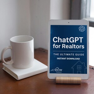 May include: A white mug and a white book rest on a brown surface. A tablet displays the text "ChatGPT for Realtors" with the subtitle "The Ultimate Guide" and the words "Instant Download". The tablet is supported by a wooden stand.