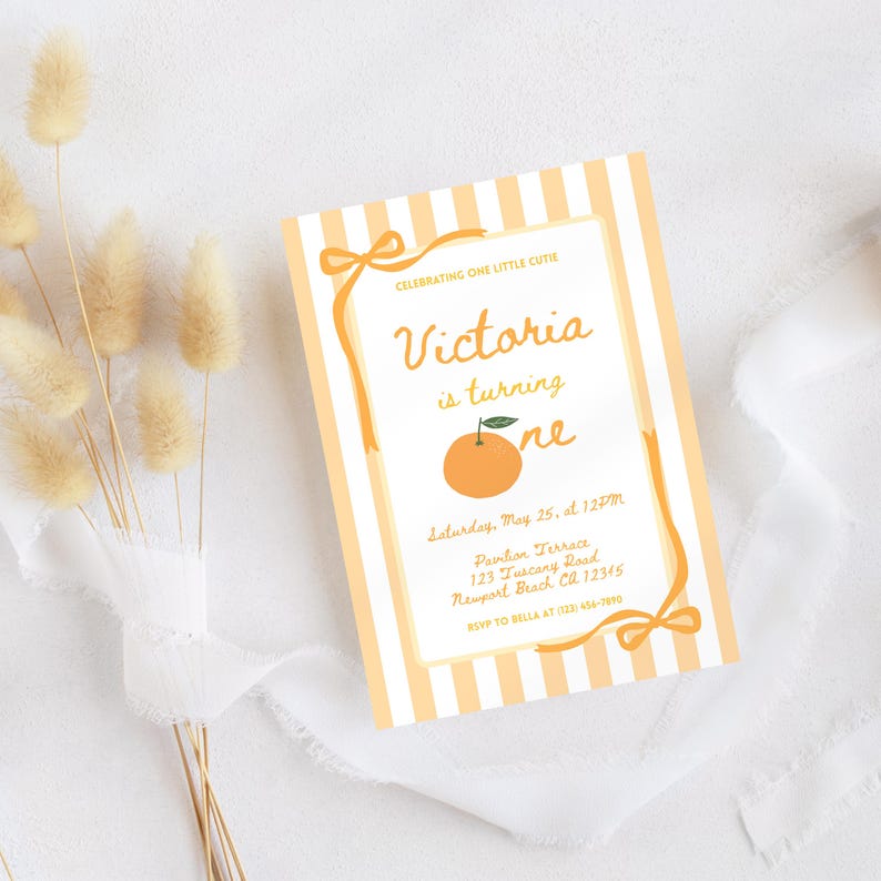 May include: A rectangular invitation with a striped orange and white background. The text "Victoria is turning one" is in a handwritten style. An orange illustration is in the center. The invitation includes event details and RSVP information.