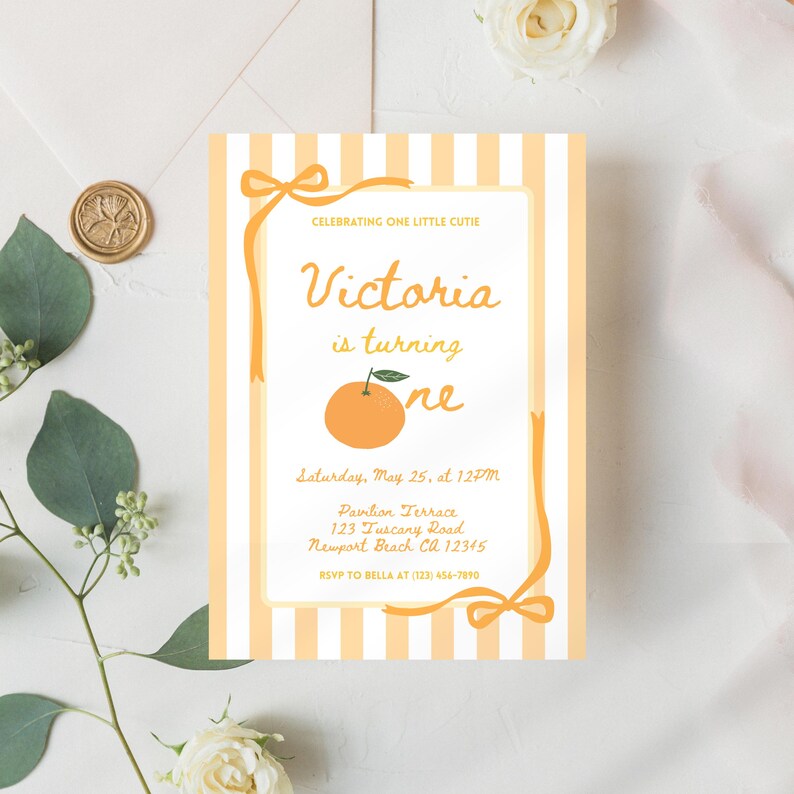 May include: A birthday invitation with an orange and white striped background. The invitation features the text "Victoria is turning one" with an illustration of an orange. The invitation also includes the date, time, and location of the party.