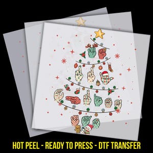 May include: A Christmas tree design made of hand signs in various colors, with a star on top and festive decorations. The image includes the text "HOT PEEL - READY TO PRESS - DTF TRANSFER" in yellow.
