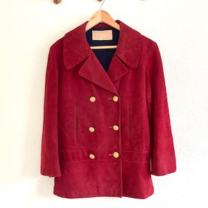 May include: A red suede double-breasted peacoat with gold buttons.