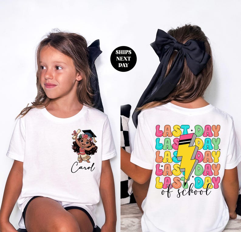 A young girl wearing a white t-shirt with a cartoon character and text printed on it.