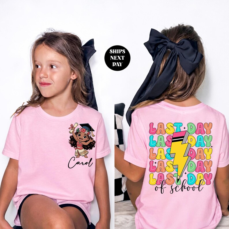 a young girl wearing a pink t-shirt with a cartoon character and text on the back.