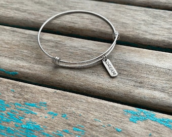Dream Bracelet-  laser engraved charm on a stainless steel adjustable bangle bracelet