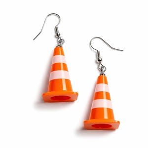 May include: A pair of novelty earrings featuring miniature orange and white striped traffic cones. The earrings have silver-colored fish hook ear wires and are set against a white background.