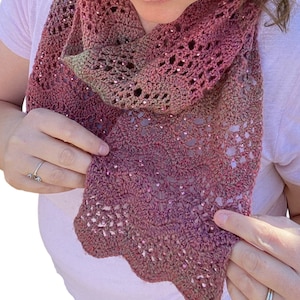 May include: A pink and green crocheted scarf with a scalloped edge and beaded accents.