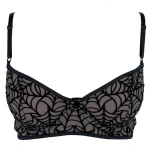 May include: A black bra with a spiderweb design. The bra features adjustable black straps and a delicate, patterned overlay. The cups are a neutral color, and the overall design is intricate and detailed.