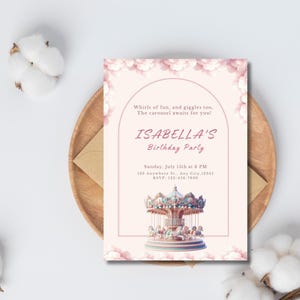 May include: A light pink birthday party invitation with a carousel illustration. The invitation includes the text "Whirls of fun, and giggles too, The carousel awaits for you!" and "ISABELLA'S Birthday Party". The invitation is on a wooden plate with cotton.