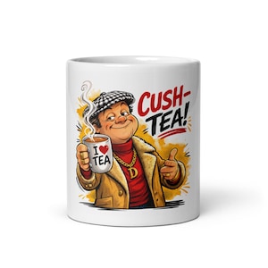 May include: White ceramic mug featuring a cartoon illustration of a man holding a steaming cup of tea. The mug has the text "I ❤️ TEA" on the cup and "CUSH-TEA!" on the mug. The man is wearing a brown coat, a red turtleneck, and a gold chain.