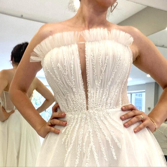 pearl beaded back wedding dress Stunning Deep V-Neck a line wedding dress with Pearls, Beaded Detailing, and Sweep Train