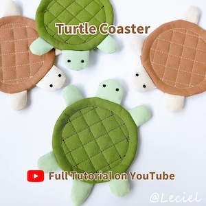 May include: Three fabric turtle coasters in green and brown with quilted shell patterns, light green heads, and black stitched eyes. The text reads Turtle Coaster and Full Tutorial on YouTube with a red play icon and the handle @Leciel.