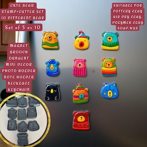 May include: A collection of colorful bear-shaped magnets and stamps. The magnets feature various designs with different outfits and colors. Text on the image reads "CUTE BEAR STAMP+CUTTER SET 10 DIFFERENT BEAR" and "MAGNET BROOCH ORNAMENT MINI DECOR PHOTO HOLDER NOTE HOLDER NECKLACE KEYCHAIN."