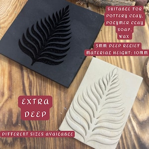 May include: Two rectangular clay stamps featuring a leaf design. One is black with a recessed leaf, the other is beige with a raised leaf. Text on the image reads "EXTRA DEEP" and "DIFFERENT SIZES AVAILABLE". Suitable for pottery clay, polymer clay, soap, and wax.
