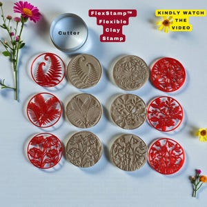 May include: A collection of flexible clay stamps and a cutter. The stamps feature various botanical designs, including ferns and floral patterns, in red and tan colors. The text "FlexStamp Flexible Clay Stamp" is displayed in a red box. The cutter is silver and has the word "Cutter" on it.