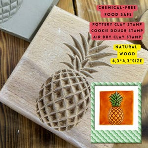 May include: A natural wood stamp with a carved pineapple design. The stamp is 4.3 x 4.3 inches and is suitable for pottery clay, cookie dough, and air dry clay. The image also includes a small, colorful pineapple illustration.