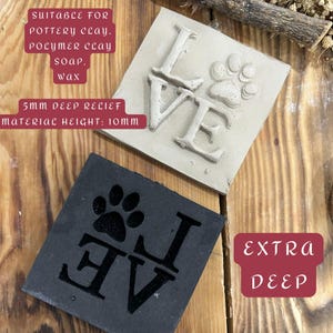 May include: Two square stamps with the word "LOVE" and a paw print. One stamp is light gray, the other is black. The text "SUITABLE FOR POTTERY CLAY, POLYMER CLAY, SOAP, WAX" is visible. The material height is 10mm.