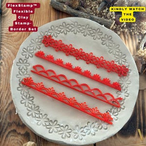 May include: A set of four red flexible clay stamp border designs. The stamps are arranged on a round, light gray surface with a floral pattern. The text "FlexStamp Flexible Clay Stamp-Border Set" is visible.