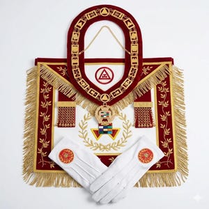 May include: A ceremonial set featuring a red and gold collar, apron, and white gloves. The apron has gold fringe and embroidered details. The collar has gold chain links and a pendant. The gloves have red and gold emblems.