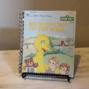 May include: A spiral-bound Little Golden Book titled Big Bird's Day on the Farm featuring a large yellow Big Bird character, a brown teddy bear, and two children on the cover. The Sesame Street logo is visible in the top right corner.