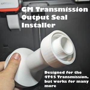 May include: White GM Transmission Output Seal Installer. The tool is designed for the 4T45 Transmission, but works for many more. The text "GM Transmission Output Seal Installer" is visible.