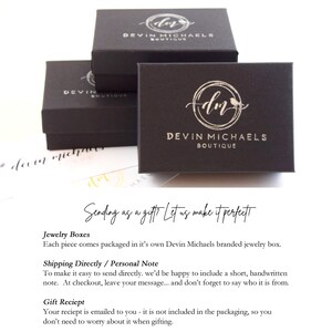 May include: Black jewelry boxes with a silver logo that says "Devin Michaels Boutique" and a stylized "dm" with a bird. The text "Sending as a gift? Let us make it perfect" is written in white on a black background.