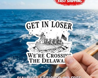 May include: A white sticker with black text and a black and white illustration of a boat crossing a river. The text reads "GET IN LOSER WE'RE CROSSING THE DELAWARE". A red "FAST SHIPPING" graphic is in the upper right.