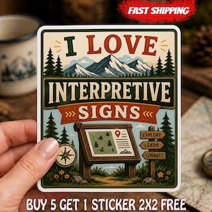 May include: A rectangular sticker featuring a mountain landscape with pine trees and the text I LOVE INTERPRETIVE SIGNS. It includes an illustration of an information kiosk with a map, a compass, and three directional signs labeled EXPLORE, LEARN, and CONNECT.