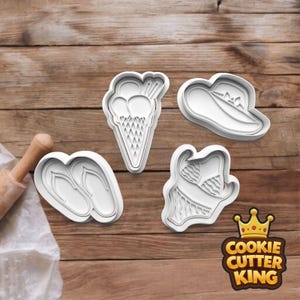 May include: Four white plastic cookie cutters in summer shapes: an ice cream cone, a sun hat, flip-flops, and a swimsuit. The Cookie Cutter King logo is in the bottom right corner. The cutters are on a wooden surface.
