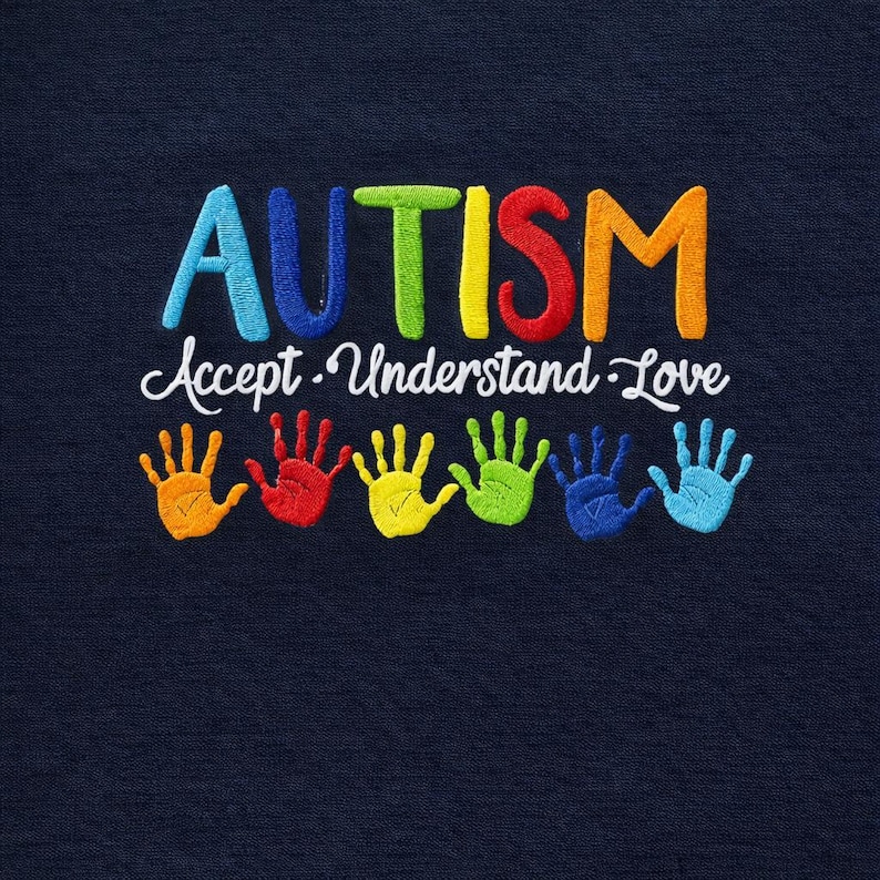 May include: Navy blue fabric with embroidered text and handprints. The word "AUTISM" is in colorful letters above the words "Accept. Understand. Love." Below are six handprints in various colors, including orange, red, yellow, green, blue, and light blue.