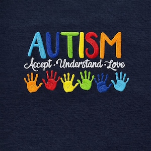 May include: Navy blue fabric with embroidered text and handprints. The word "AUTISM" is in colorful letters above the words "Accept. Understand. Love." Below are six handprints in various colors, including orange, red, yellow, green, blue, and light blue.