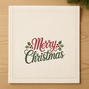 May include: Cream-colored rectangular table runner with the embroidered text "Merry Christmas" in red and green. The design includes holly leaves and berries. The edges are finished with a dotted stitch.