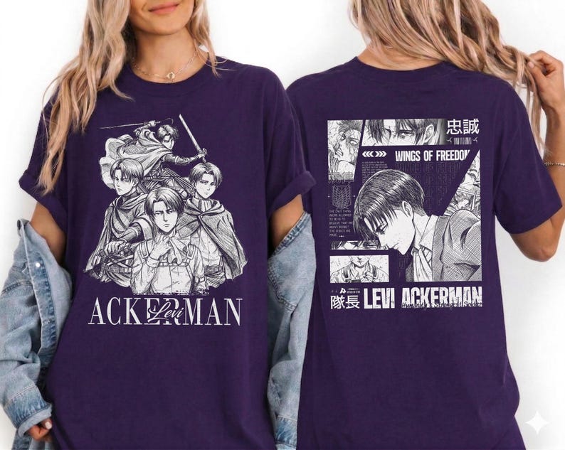 May include: A dark purple t-shirt featuring a manga-style illustration of several characters. The front of the shirt has the word "ACKERMAN" in white. The back of the shirt has a manga panel with the words "WINGS OF FREEDOM" and "LEVI ACKERMAN".