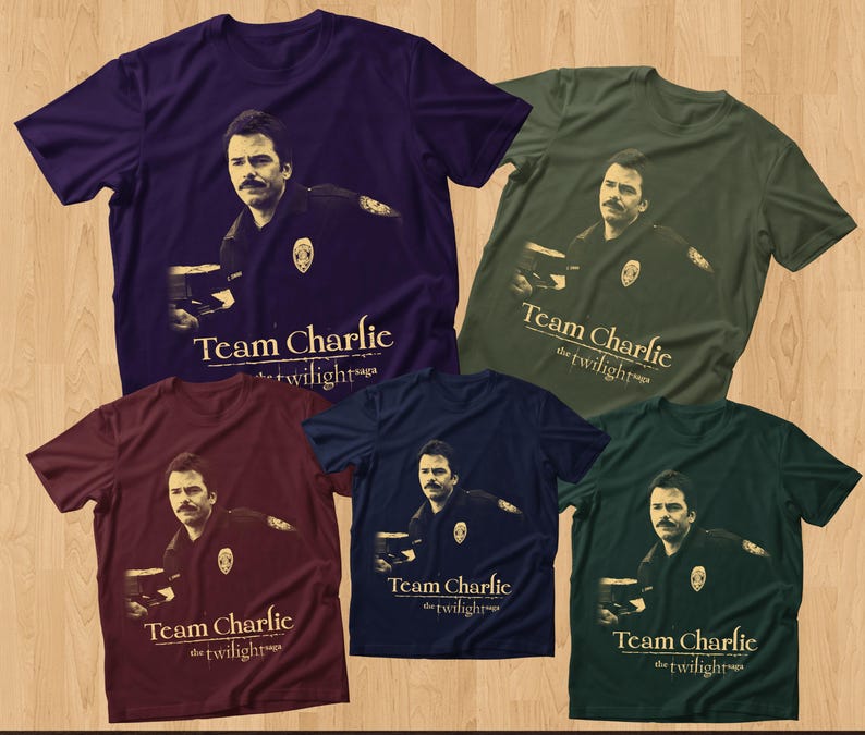 May include: Five t-shirts in various colors: purple, olive green, burgundy, navy blue, and dark green. Each shirt features a graphic of a man and the text "Team Charlie the twilight saga."