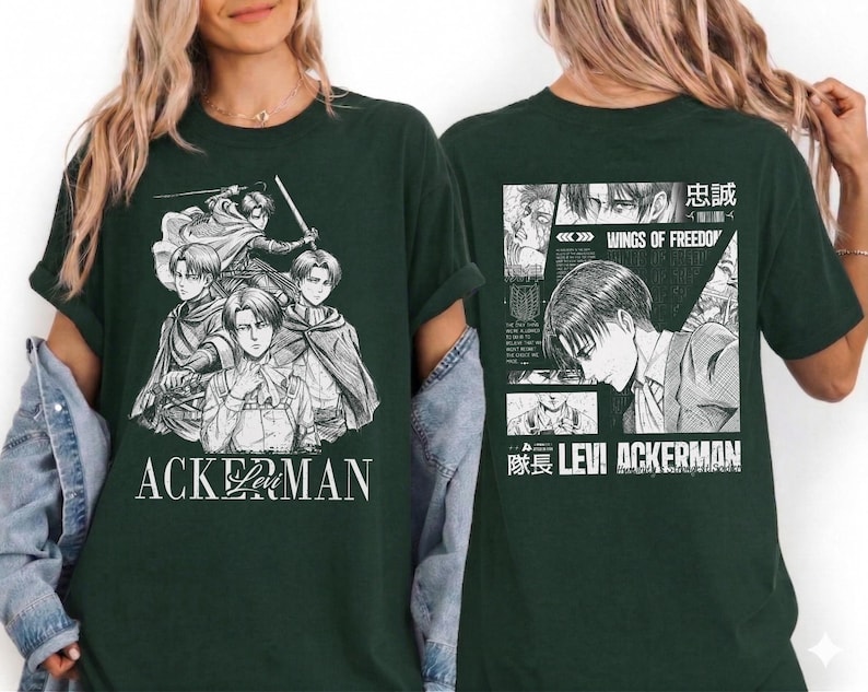 May include: Dark green t-shirt featuring a black and white graphic of anime characters. The front of the shirt displays the word "ACKERMAN" in white. The back of the shirt has a manga-style design with Japanese text and the words "WINGS OF FREEDOM".