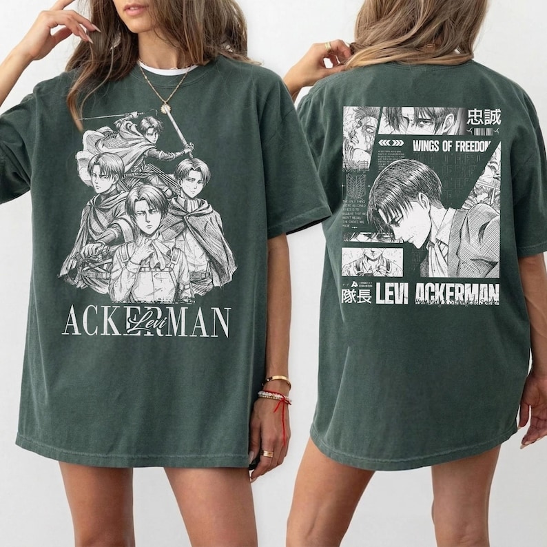 May include: Dark green t-shirt featuring a black and white graphic of anime characters with the text "ACKERMAN" on the front. The back of the shirt displays additional anime imagery and the text "LEVI ACKERMAN".