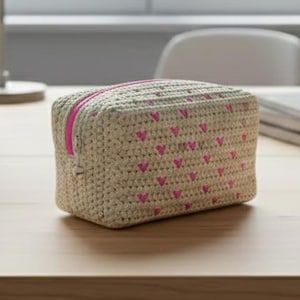 May include: A white ceramic mug with a black handle and the text "But First, Coffee" in a bold, black font. The mug is set against a blurred background, suggesting a cozy setting.