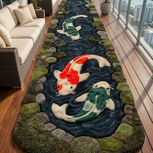 May include: A long, rectangular rug featuring a koi pond design. The rug has a dark blue background with three koi fish in shades of red, white, and green. The edges are lined with green and gray textured elements.