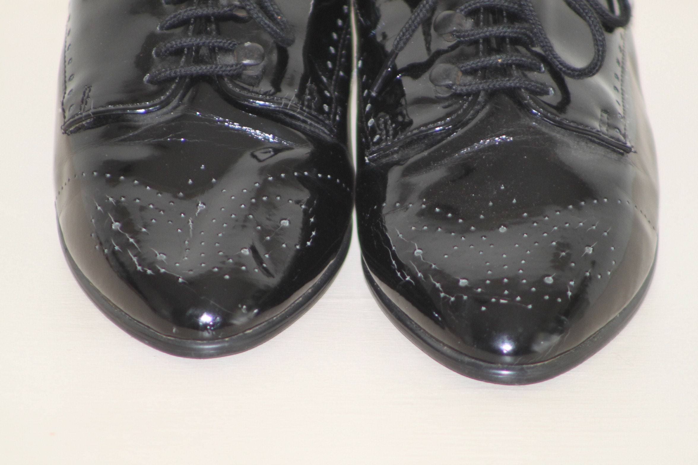 black patent leather wingtip shoes