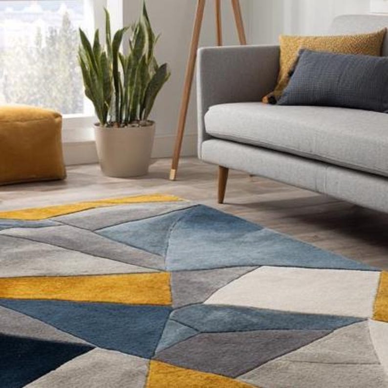 Contemporary blue and mustard rug, artisan-made with sculpted hand-tufting, designed for elegant UK and EU living spaces. Handmade geometric wool rug for modern apartments, featuring a bold and elegant color contrast for European design lovers.