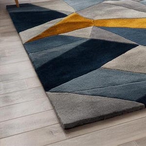 Contemporary rug in navy, mustard, and grey tones, designed for minimalist interiors and Scandinavian-style UK apartments.Hand-tufted geometric rug with a modern color palette, ideal for eco-conscious European interiors and stylish living rooms.