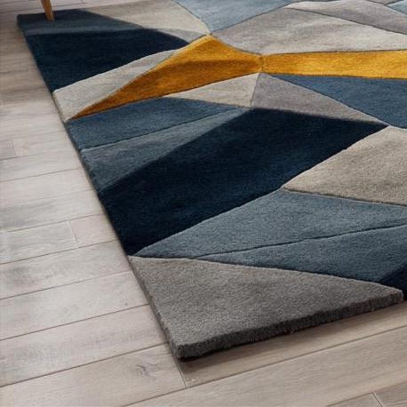 Contemporary rug in navy, mustard, and grey tones, designed for minimalist interiors and Scandinavian-style UK apartments.Hand-tufted geometric rug with a modern color palette, ideal for eco-conscious European interiors and stylish living rooms.