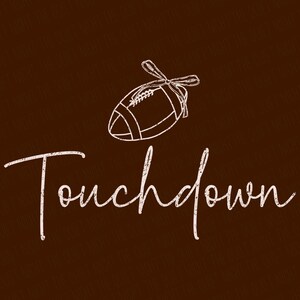 May include: A brown background with a white football illustration tied with a bow. The word "Touchdown" is written in a cursive font below the football. The design has a distressed, vintage look.